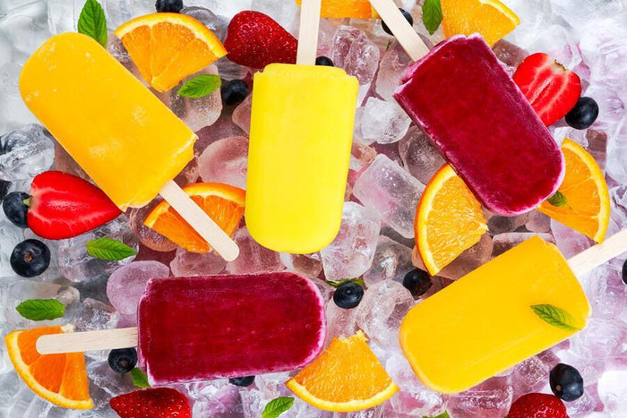 assortments of orange lemon and strawberry popsicles